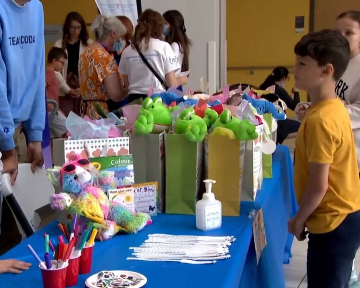 A hospitalized child waiting for his gift bag during our 2023 Teddy Bear Clinic event