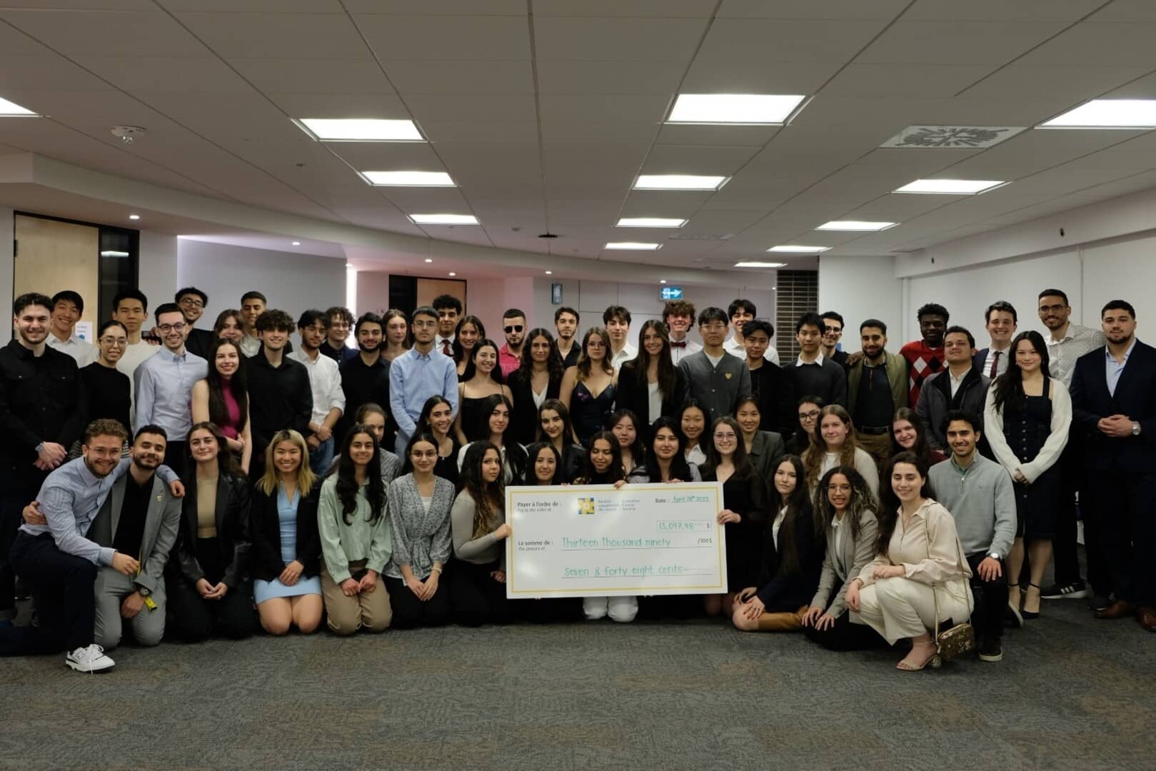 Our large team of students holding a giant cheque