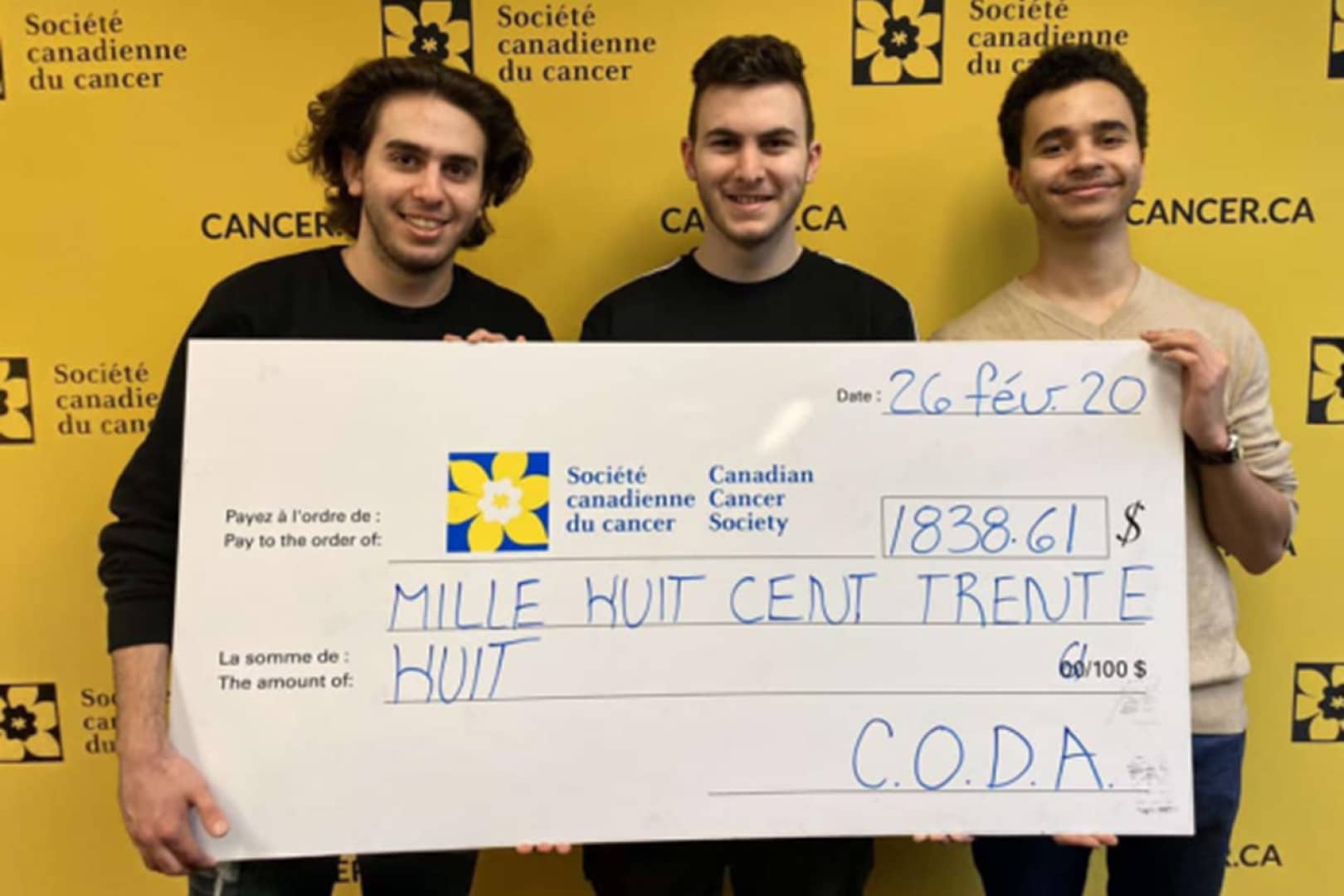 Members of the CODA Marianopolis club holding a giant cheque for the Canadian Cancer Society