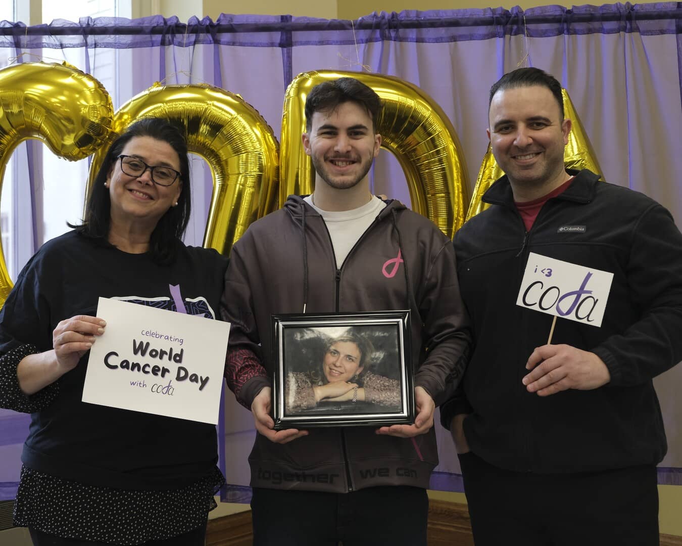 One of our members holding a picture of a loved one at our 2023 World Cancer Day event